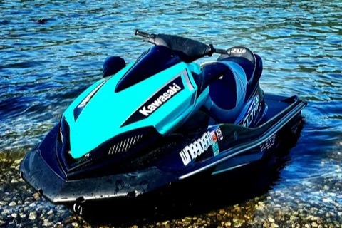 Teal Kawasaki jet ski on the lake